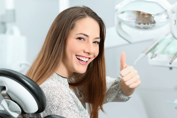 Dental patient showing the thumbs up
