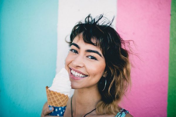 Lady with sensitive teeth eating ice cream
